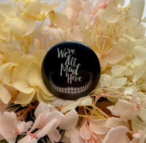 We're All Mad Here Badge